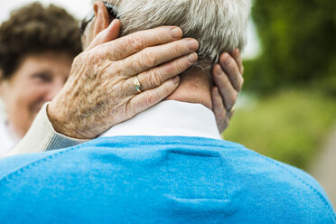 Senior woman embracing her husband, close-up - UUF004535