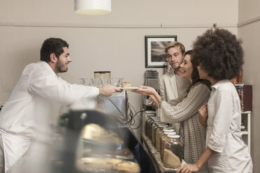 Customers queuing at cake counter in coffee shop - ZEF006640