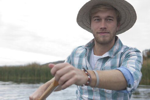 Portrait of young man paddling on a lake - ZEF005793