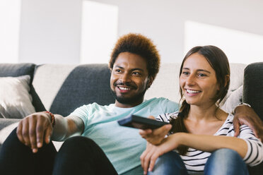 Happy young couple watching TV - EBSF000678