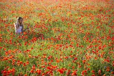 Germany, Bavaria, girl in a poppy field - YRF000081