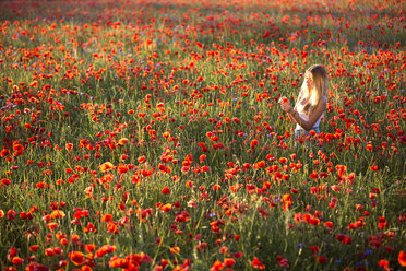 Germany, Bavaria, girl in a poppy field - YRF000082