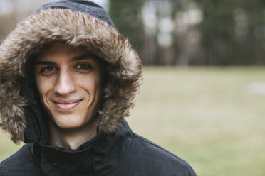 Portrait of smiling man wearing parka - BZF000159