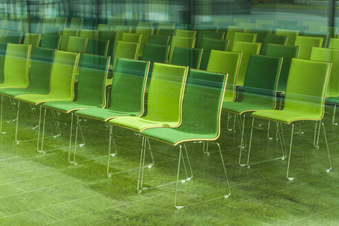 Chairs in a conference room, seeing through glass pane - TCF004689