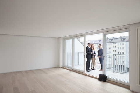 Young couple viewing flat with estate agent stock photo