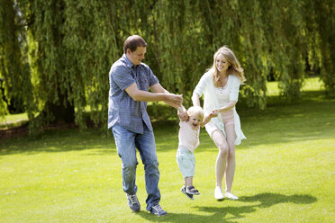 Parents playing with their little son in a park - GDF000750