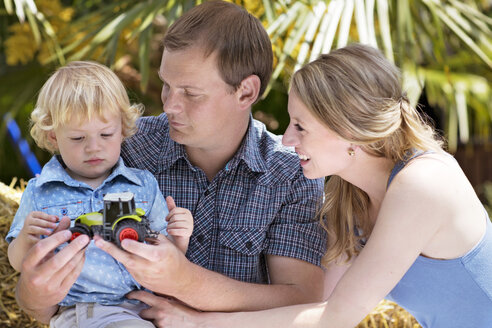 Father showing his little son toy tractor - GDF000760