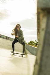 Young woman skate boarding in a skatepark - UUF004594