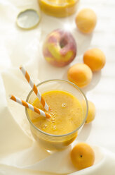 Peach apricot smoothie in glass, drinking straws - ODF001130