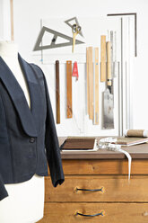 Jacket on dressmaker's model and tools in manufacturer's workshop - FKF001189