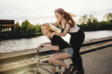 Two friends riding BMX bicycle together - GCF000114