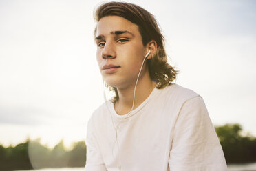Portrait of young man with earbuds - GCF000080