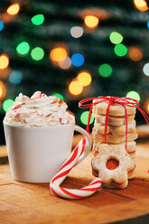 Cup of cappuccino, candy cane and stack of Christmas cookies - BZF000167