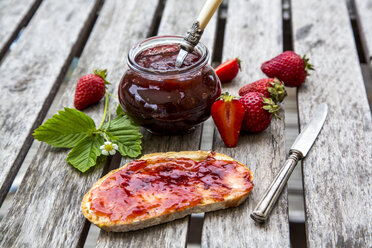 Erdbeermarmelade im Glas, Erdbeeren und Brot mit Marmelade auf Holz - SARF001856