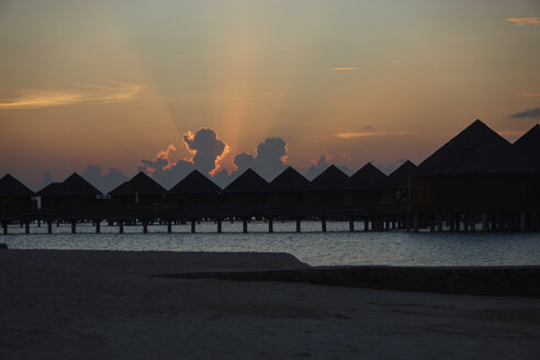 Malediven, Pfahlbau-Resort bei Sonnenuntergang - STKF001280