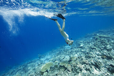 Maldives, woman snorkeling in the Indian Ocean - STKF001292