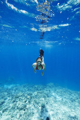 Maldives, woman snorkeling in the Indian Ocean - STKF001294