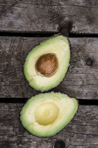 Sliced avocado on wood stock photo