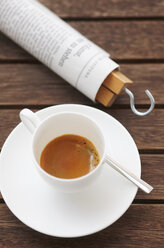 Cup of espresso and rolled newspaper - JTF000674