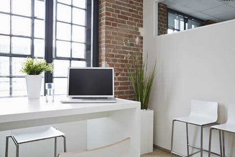 Laptop on desk in modern office stock photo