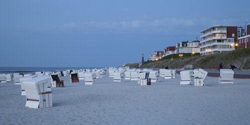 Germany, Lower Saxony, East Frisia, Wangerooge, Beach with beach chairs in the evening, Panorama - WIF002210