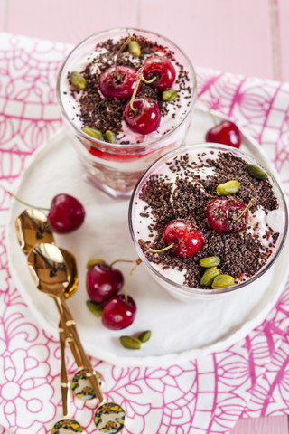 Glass of yoghurt dessert with cherries stock photo
