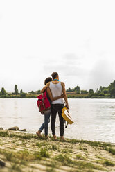 Young couple embracing by the riverside - UUF004785
