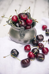 Fresh cherries in bowl, on white cloth - SARF001909