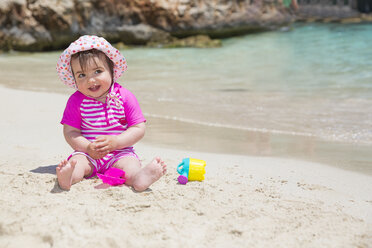 Spain, Baleares, Mallorca, baby girl playing on sandy beach - ROMF000047