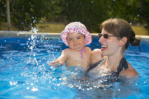 Spain, Mallorca, mother and her little daughter together in a swimming pool stock photo