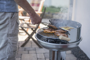 Man grilling beef on his terrace - PAF001431