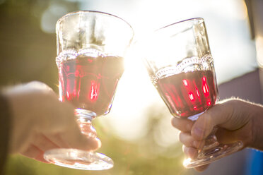 Toasting with glasses of red wine, close-up - SARF001928