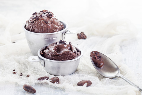 Cups of homemade chocolate icecream sprinkled with cacao nibs stock photo