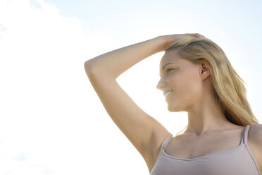 Smiling woman with hand on her head - BFRF001251