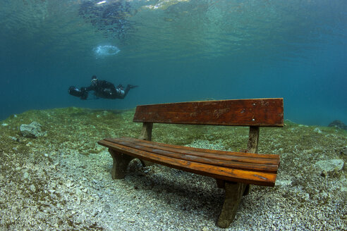 Austria, Styria, Tragoess, lake Gruener See, diver and flooded park bench - YRF000086