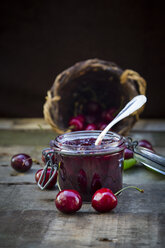 Jar of cherry jam and cherries on wood - LVF003543