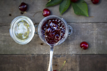 Jar of cherry jam and cherries on wood - LVF003541