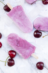 Cherry yoghurt ice lollies and cherries on white marble - LVF003567