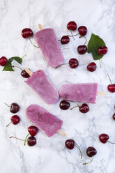 Cherry yoghurt ice lollies and cherries on white marble - LVF003564