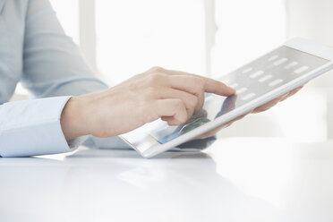 Close-up of woman's hands using digital tablet - RBF002909