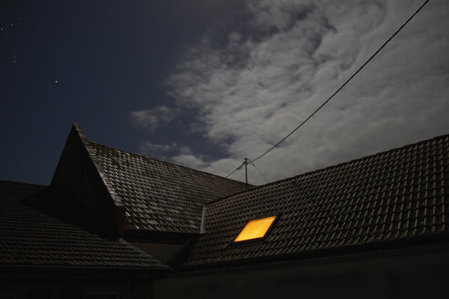 Beleuchtetes Dachfenster bei Nacht - BSCF000458