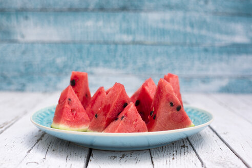 Chopped watermelon on blue plate - SARF001977