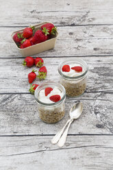 Granola, popped amarant, strawberries and yogurt in glasses - LVF003573
