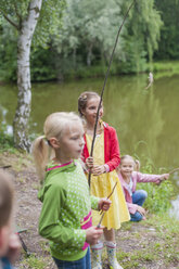 Germany, Girls with rods and small fish - MJF001540