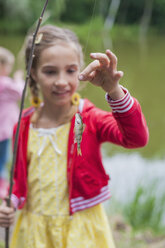 Germany, Girl with rod and small fish - MJF001542