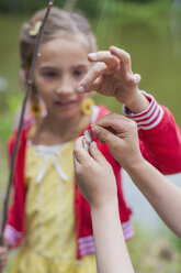 Germany, Girl with rod and small fish - MJF001543