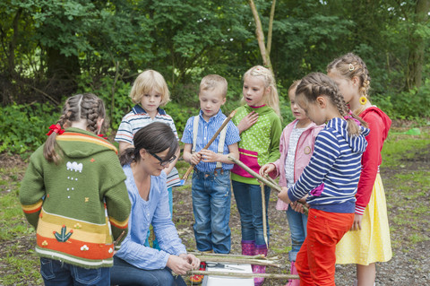 Germany, Children learning how to build a wooden raft stock photo