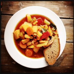 Minestrone, Italian vegetable soup with a slice of bread - SRSF000595