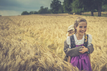 Germany, Saxony, two children standing in a grain field - MJF001577