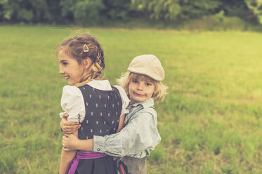 Germany, Saxony, little boy holding girl on a meadow - MJF001600